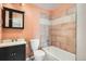 Small bathroom featuring black vanity, tile shower and tub at 492 Vance St, Lakewood, CO 80226