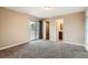 Bedroom with carpet features a slider to balcony, closet, and bathroom at 492 Vance St, Lakewood, CO 80226