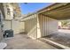 Attached carport with a concrete floor providing covered parking for vehicles and storage at 492 Vance St, Lakewood, CO 80226