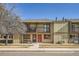 Two-story townhome featuring balconies, brick accents, and a well-kept front yard at 492 Vance St, Lakewood, CO 80226