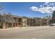 Street view showcasing townhomes with balconies and neat landscaping under a bright sky at 492 Vance St, Lakewood, CO 80226