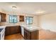 Bright kitchen featuring hardwood floors, granite countertop, and wooden cabinetry at 492 Vance St, Lakewood, CO 80226