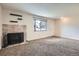 Carpeted living room featuring a decorative fireplace, bright window, and neutral paint at 492 Vance St, Lakewood, CO 80226