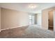 Spacious carpeted main bedroom featuring a sliding glass door and walk-in closet at 492 Vance St, Lakewood, CO 80226