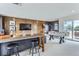 Finished basement with a bar area, a foosball table, and access to an outdoor seating area at 2475 W 69Th Pl, Denver, CO 80221