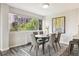 Dining room with hardwood floors and modern gray chairs at 909 N Logan St # 6K, Denver, CO 80203