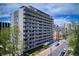 Modern high-rise apartment building with sleek architecture and balconies, set against a vibrant cityscape at 909 N Logan St # 6K, Denver, CO 80203