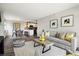 Modern living room with gray sofa and yellow accents at 909 N Logan St # 6K, Denver, CO 80203