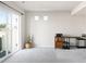 Bright bonus room featuring sliding glass doors, a snake plant, and a wooden desk at 21925 E 44Th Pl, Aurora, CO 80019