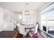 Bright dining room with a round table, six chairs, modern light fixture and a walk-out patio at 21925 E 44Th Pl, Aurora, CO 80019