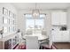 Dining room with a round table, modern light fixture and nine framed pictures on the wall at 21925 E 44Th Pl, Aurora, CO 80019