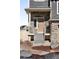 Inviting front porch showcasing a stone facade, providing an appealing entry to the residence with landscaped surroundings at 21925 E 44Th Pl, Aurora, CO 80019