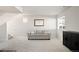 Cozy living room featuring a comfortable sofa, a modern cabinet, and a well-lit space at 21925 E 44Th Pl, Aurora, CO 80019