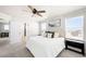 Bright main bedroom with a queen bed, ceiling fan, and ensuite bathroom with a view at 21925 E 44Th Pl, Aurora, CO 80019