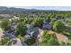This aerial view shows a house in a tree-lined neighborhood with well-kept lawns at 9147 W Rockland Pl, Littleton, CO 80128
