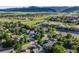 Aerial view of houses located near a school, fields, and the mountains in the background at 9147 W Rockland Pl, Littleton, CO 80128