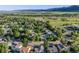 This aerial view showcases houses in a neighborhood abundant with trees and well-manicured lawns at 9147 W Rockland Pl, Littleton, CO 80128