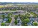 This aerial view shows the home in a neighborhood close to a school and the mountains beyond at 9147 W Rockland Pl, Littleton, CO 80128