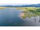 This aerial view shows the community lake area with beach, picnic areas and other amenities at 9147 W Rockland Pl, Littleton, CO 80128