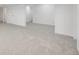 Spacious basement featuring neutral carpet, white walls, and ample lighting at 9147 W Rockland Pl, Littleton, CO 80128
