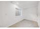 Basement bedroom with egress window, carpet, and neutral paint at 9147 W Rockland Pl, Littleton, CO 80128