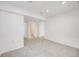 Finished basement area with carpet and doorway to bathroom at 9147 W Rockland Pl, Littleton, CO 80128