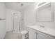 Clean bathroom with shower, modern vanity, and decorative lighting creating a refreshing and functional space at 9147 W Rockland Pl, Littleton, CO 80128