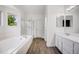 Bright bathroom features a soaking tub and shower combo at 9147 W Rockland Pl, Littleton, CO 80128