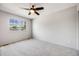 Neutral bedroom with large window and ceiling fan offering a bright and airy space at 9147 W Rockland Pl, Littleton, CO 80128