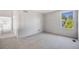This bedroom offers neutral carpet and a window for natural light at 9147 W Rockland Pl, Littleton, CO 80128