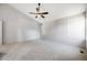 Bright bedroom with a ceiling fan, vaulted ceiling, and large windows at 9147 W Rockland Pl, Littleton, CO 80128
