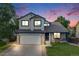 Charming two-story home with a well-manicured lawn and attached two-car garage at 9147 W Rockland Pl, Littleton, CO 80128