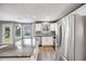 Modern kitchen featuring stainless steel appliances, a large island, and ample counter space at 9147 W Rockland Pl, Littleton, CO 80128