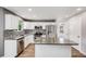 Bright kitchen boasts white cabinets, stainless steel appliances, granite counters, and stylish backsplash at 9147 W Rockland Pl, Littleton, CO 80128