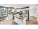 Open kitchen featuring stainless steel appliances, granite counters, and an island with seating at 9147 W Rockland Pl, Littleton, CO 80128
