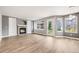 Inviting living room with a fireplace, built-in bookshelves, and large windows at 9147 W Rockland Pl, Littleton, CO 80128