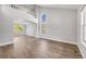 Bright and airy living room with large windows, neutral walls, and stylish hardwood floors at 9147 W Rockland Pl, Littleton, CO 80128