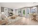 Cozy living room with a brick fireplace, built-in shelves, and light-filled windows at 9147 W Rockland Pl, Littleton, CO 80128