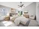 A well-lit main bedroom with a ceiling fan, neutral tones, and generous window views at 9147 W Rockland Pl, Littleton, CO 80128