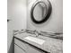 Elegant powder room with a stylish sink, granite countertop, and mosaic tile backsplash at 9147 W Rockland Pl, Littleton, CO 80128