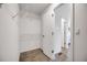 Walk-in closet with built in shelving and access to en-suite bathroom at 9147 W Rockland Pl, Littleton, CO 80128