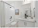 Well-lit bathroom featuring a shower-tub combo, toilet, and vanity with a sink at 5037 N Quemoy St, Aurora, CO 80019