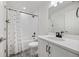 Charming bathroom with patterned floors features a shower/tub combo and black hardware at 5037 N Quemoy St, Aurora, CO 80019