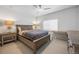 Bedroom with ceiling fan, window and side tables. Hardwood floors, neutral color palette at 5037 N Quemoy St, Aurora, CO 80019