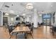 Clubhouse dining room with tables, chairs, wood floors, and hanging lights at 5037 N Quemoy St, Aurora, CO 80019