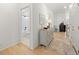 Entryway featuring hardwood floors, complemented by an accent cabinet and an adjacent bathroom at 5037 N Quemoy St, Aurora, CO 80019