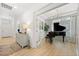 Hallway featuring hardwood floors leading to a piano room, and a foyer at 5037 N Quemoy St, Aurora, CO 80019