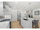 Well-lit kitchen featuring a center island, stainless steel appliances, and a view into the adjacent living spaces at 5037 N Quemoy St, Aurora, CO 80019