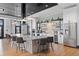 Modern clubhouse kitchen with a large island, stainless steel appliances, and tile backsplash at 5037 N Quemoy St, Aurora, CO 80019