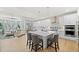 Modern kitchen with a center island, stainless steel appliances, white cabinets, and open layout to the living area at 5037 N Quemoy St, Aurora, CO 80019